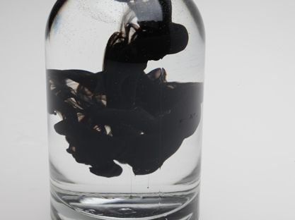 Photography - dark black color in water in glass bottle