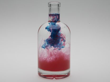 Photography - floating blue and red color in water in glass bottle