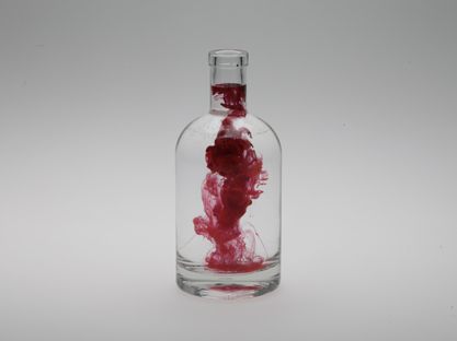 Photography - floating red color in water in glass bottle
