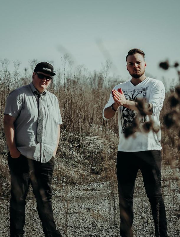 Photography of Deathcoustic band members standing in a field